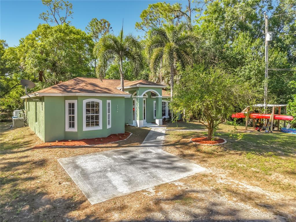 2730 68th Avenue Northeast Naples, FL 34120 - Photo 1 of 86 a front view of a house with a garden