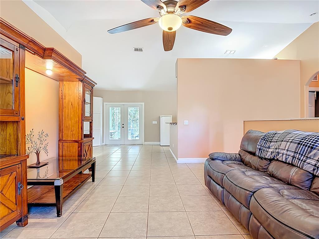 2730 68th Avenue Northeast Naples, FL 34120 - Photo 11 of 86 a living room with furniture and a chandelier