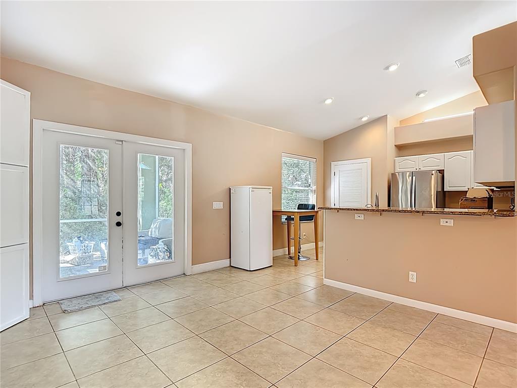 2730 68th Avenue Northeast Naples, FL 34120 - Photo 15 of 86 a view of kitchen with furniture and large window