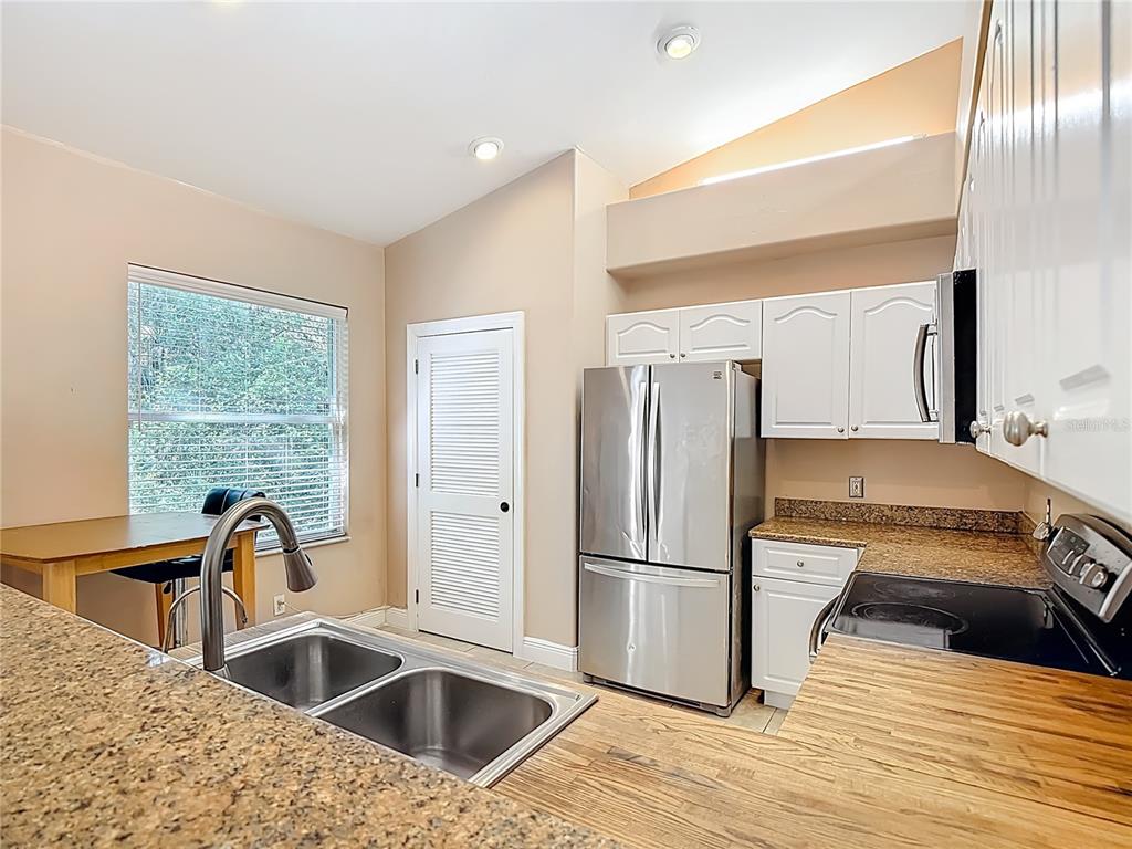 2730 68th Avenue Northeast Naples, FL 34120 - Photo 18 of 86 a kitchen with granite countertop a refrigerator and a sink
