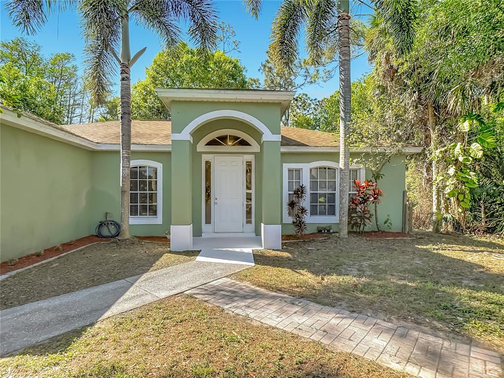 2730 68th Avenue Northeast Naples, FL 34120 - Photo 2 of 86 a front view of a house with a yard