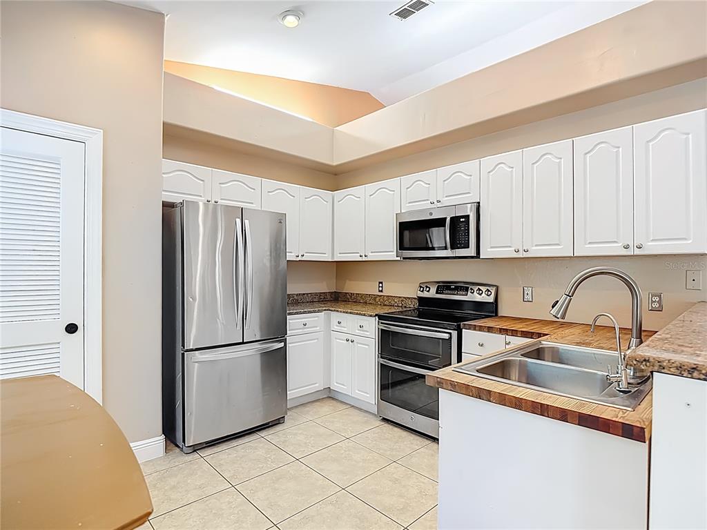 2730 68th Avenue Northeast Naples, FL 34120 - Photo 21 of 86 a kitchen with a refrigerator stove and sink