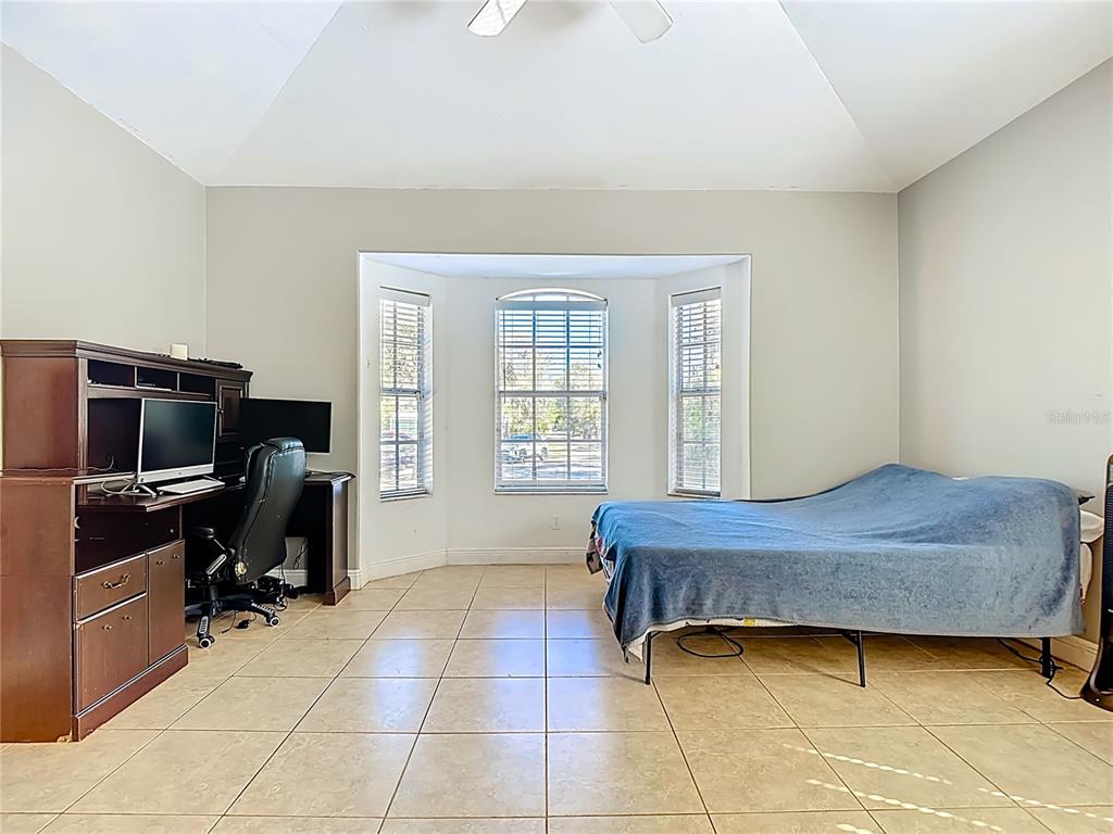 2730 68th Avenue Northeast Naples, FL 34120 - Photo 26 of 86 a bedroom with furniture and a window