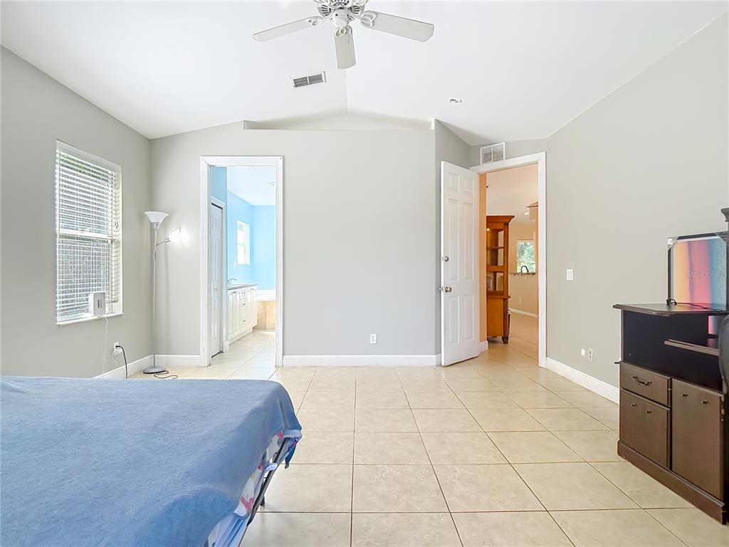 2730 68th Avenue Northeast Naples, FL 34120 - Photo 27 of 86 a spacious bathroom with a granite countertop sink a mirror and a bathtub
