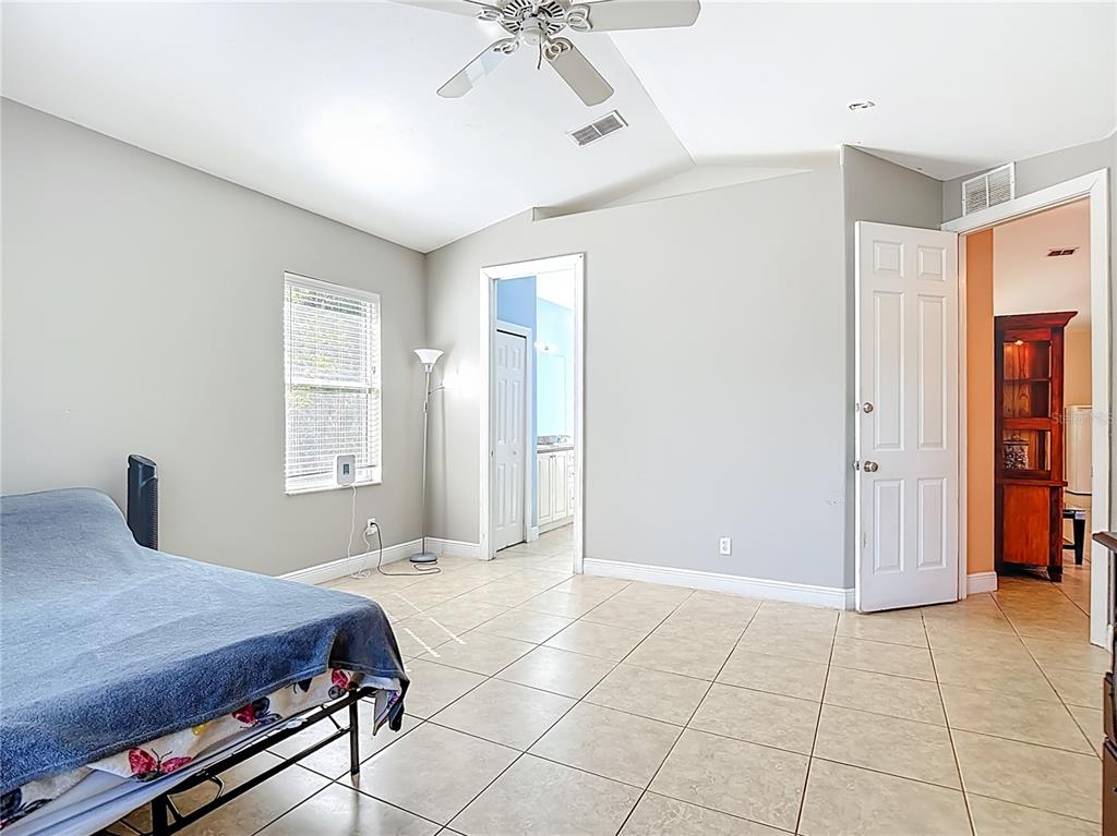 2730 68th Avenue Northeast Naples, FL 34120 - Photo 28 of 86 a bedroom with a bed and a chandelier
