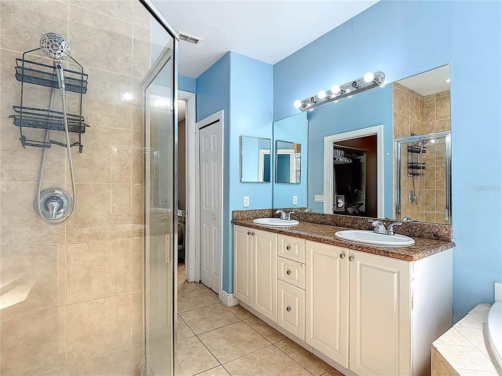 2730 68th Avenue Northeast Naples, FL 34120 - Photo 32 of 86 a bathroom with a granite countertop shower sink and a mirror