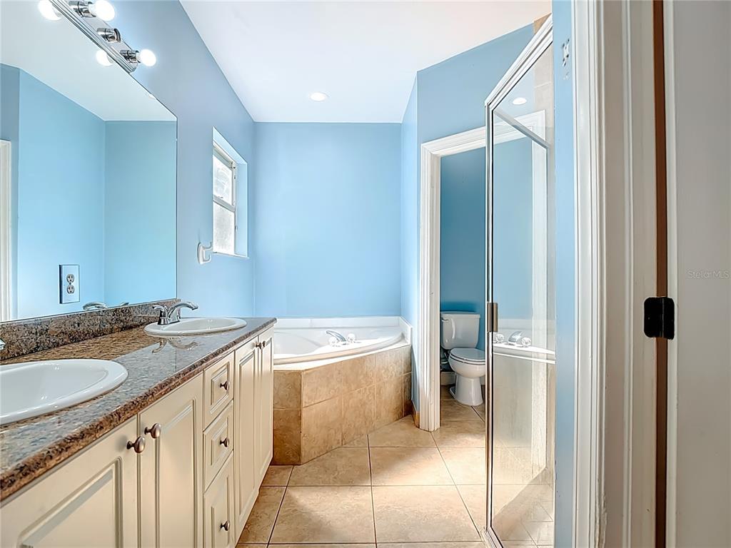 2730 68th Avenue Northeast Naples, FL 34120 - Photo 33 of 86 a bathroom with a granite countertop sink and a mirror