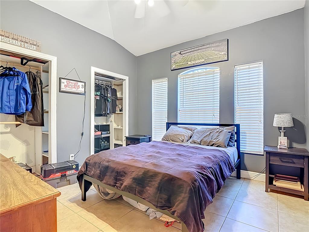 2730 68th Avenue Northeast Naples, FL 34120 - Photo 35 of 86 a bedroom with a bed and a table in it