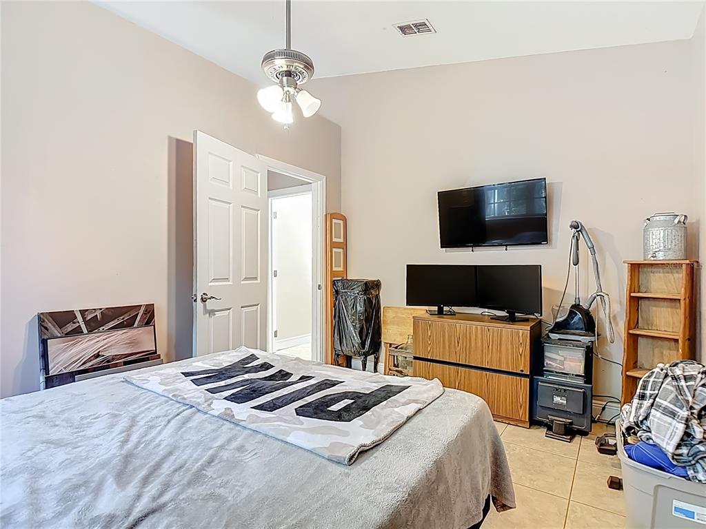 2730 68th Avenue Northeast Naples, FL 34120 - Photo 38 of 86 a bedroom with furniture and a flat screen tv