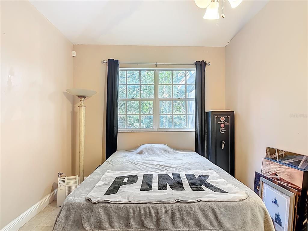 2730 68th Avenue Northeast Naples, FL 34120 - Photo 39 of 86 a bedroom with a bed and a window