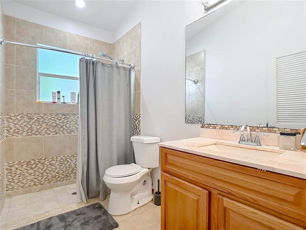 2730 68th Avenue Northeast Naples, FL 34120 - Photo 42 of 86 a bathroom with a sink toilet and shower