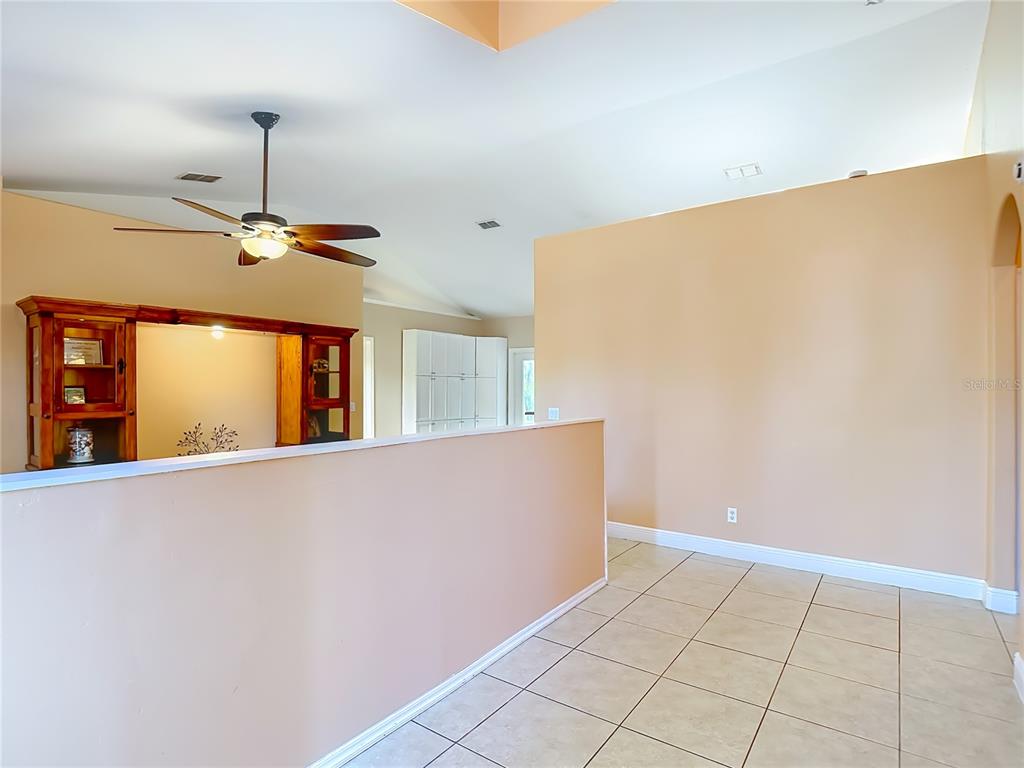2730 68th Avenue Northeast Naples, FL 34120 - Photo 6 of 86 a view of a livingroom with a ceiling fan and window