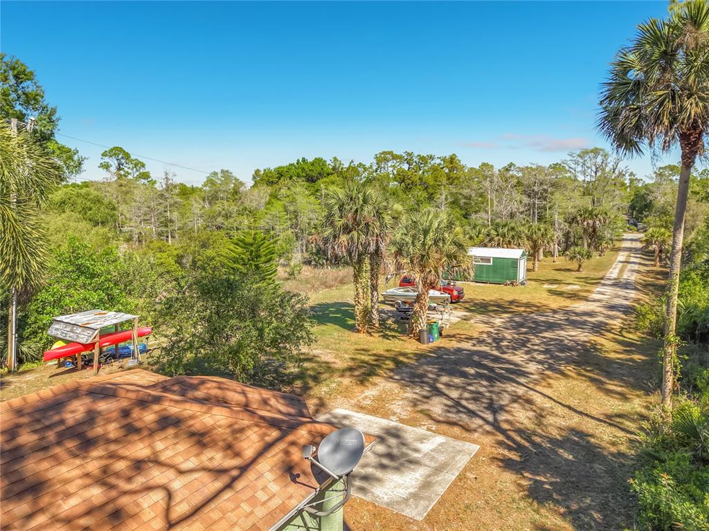 2730 68th Avenue Northeast Naples, FL 34120 - Photo 74 of 86 a backyard of a house with table and chairs