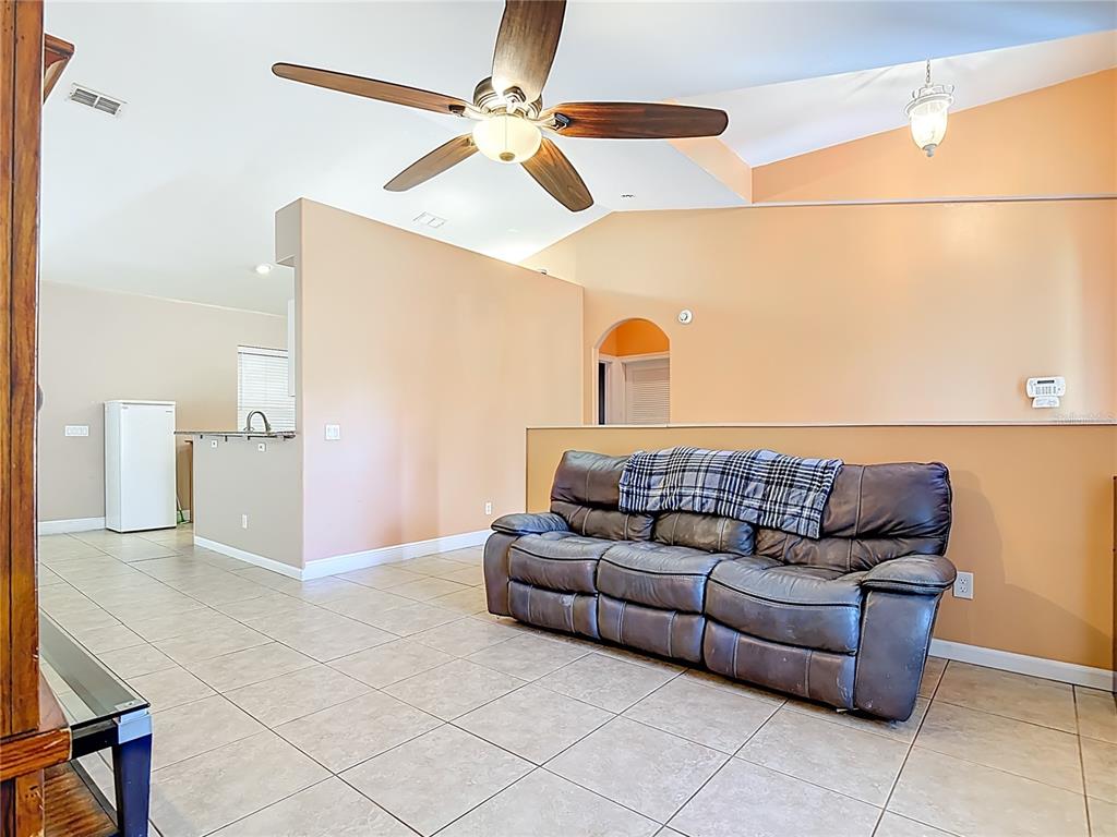 2730 68th Avenue Northeast Naples, FL 34120 - Photo 10 of 86 a living room with furniture and a rug