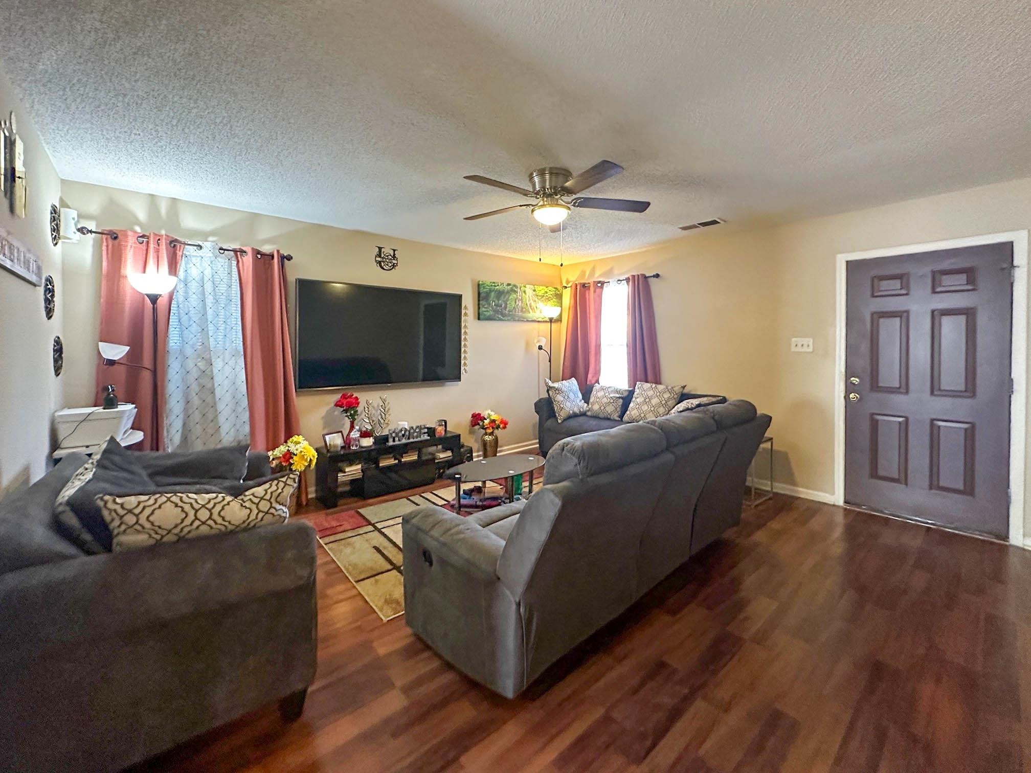 3769 Raleigh Millington Road Memphis, TN 38128 - Photo 3 of 23 Living room with dark wood finished floors, ceiling fan, and a textured ceiling