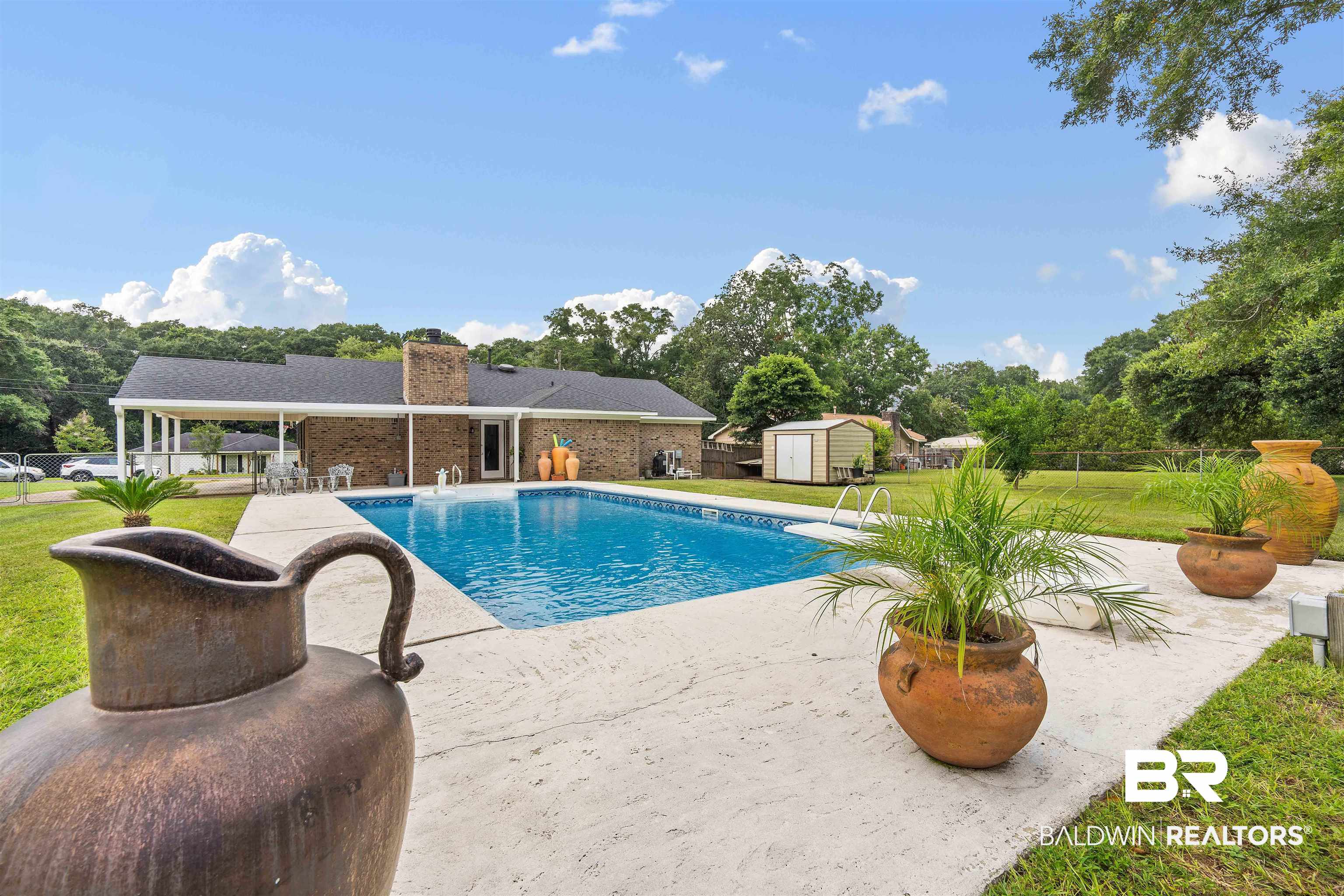 2000 Campfire Drive Semmes, AL 36575 - Photo 24 of 26 View of pool featuring a patio area and a shed