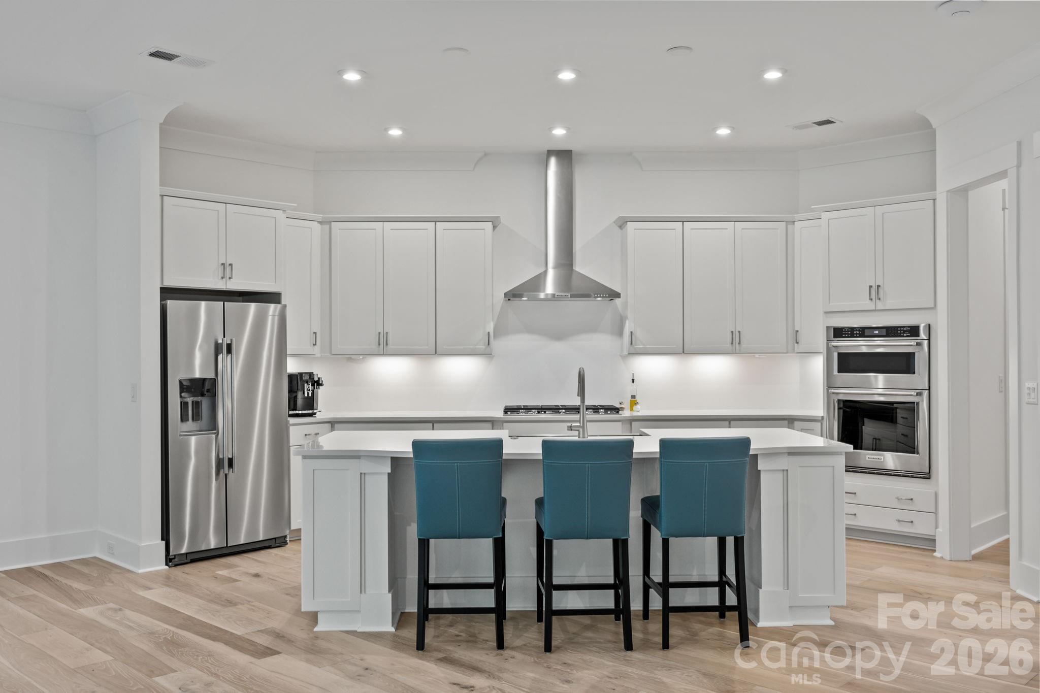 8620 Balcony Bridge Road Huntersville, NC 28078 - Photo 17 of 48 a kitchen with kitchen island cabinets and chairs in it