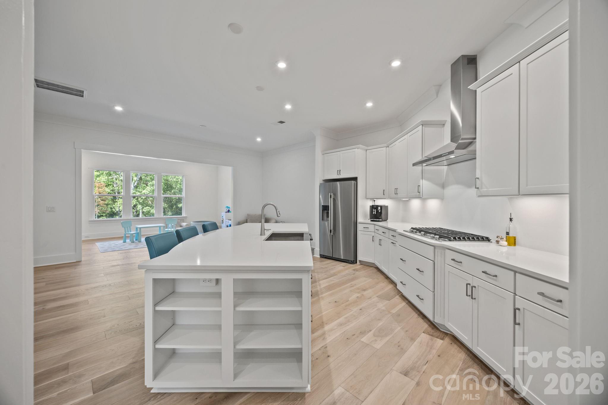 8620 Balcony Bridge Road Huntersville, NC 28078 - Photo 19 of 48 a kitchen with stainless steel appliances kitchen island granite countertop a refrigerator and a sink