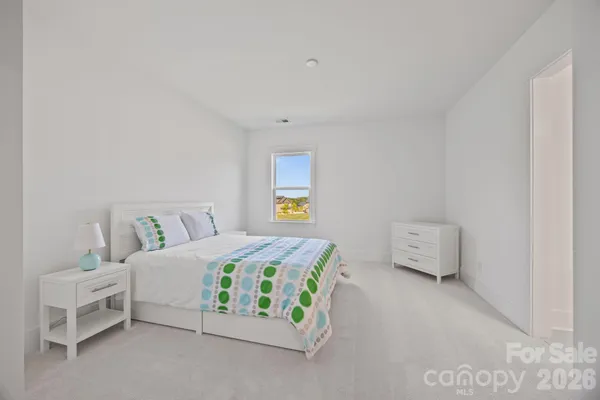 a bedroom with a bed and a desk