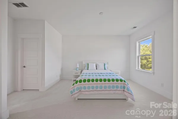 a bedroom with bed and a window