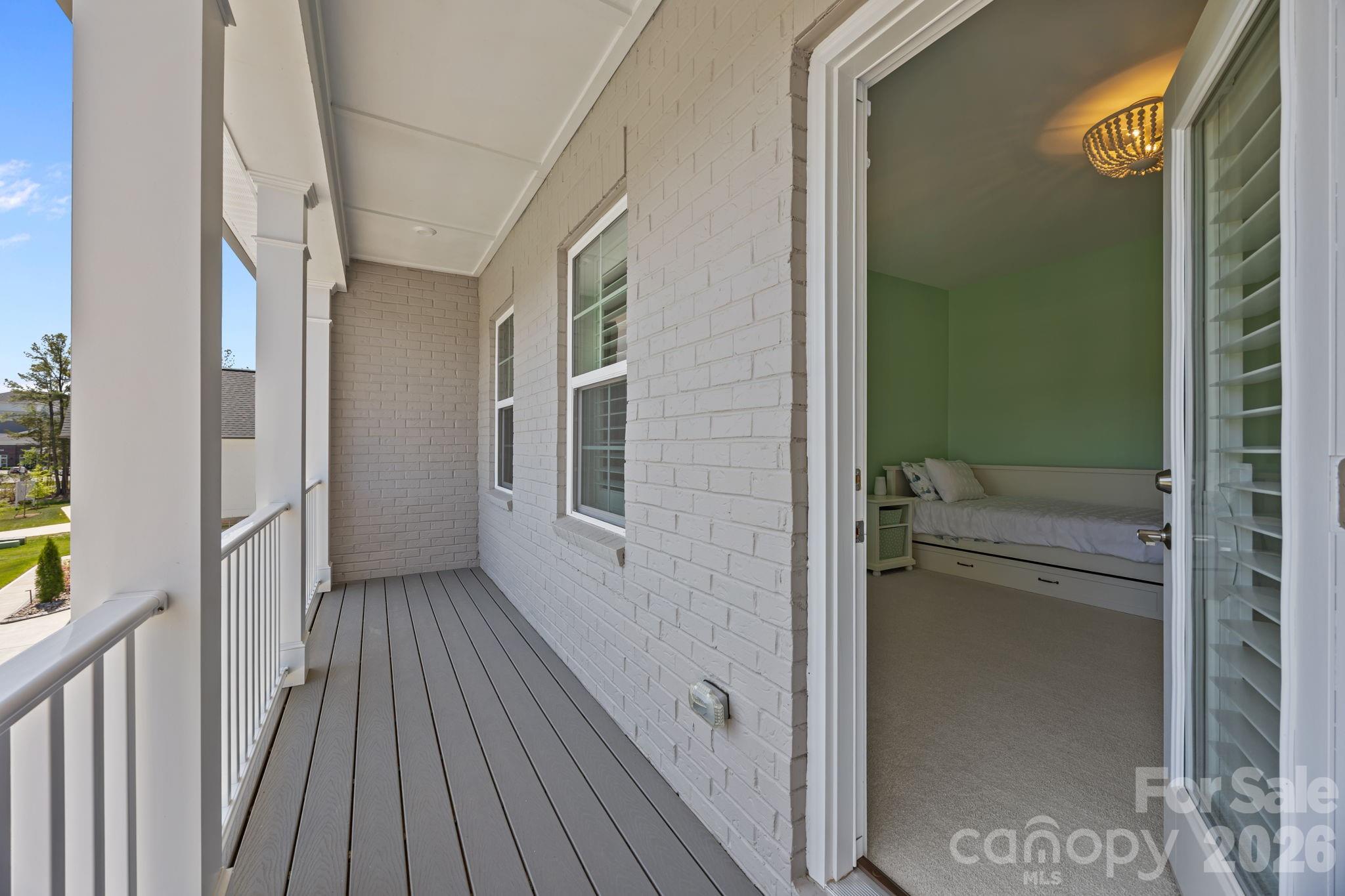 8620 Balcony Bridge Road Huntersville, NC 28078 - Photo 41 of 48 a view of a hallway with wooden floor and a bathroom