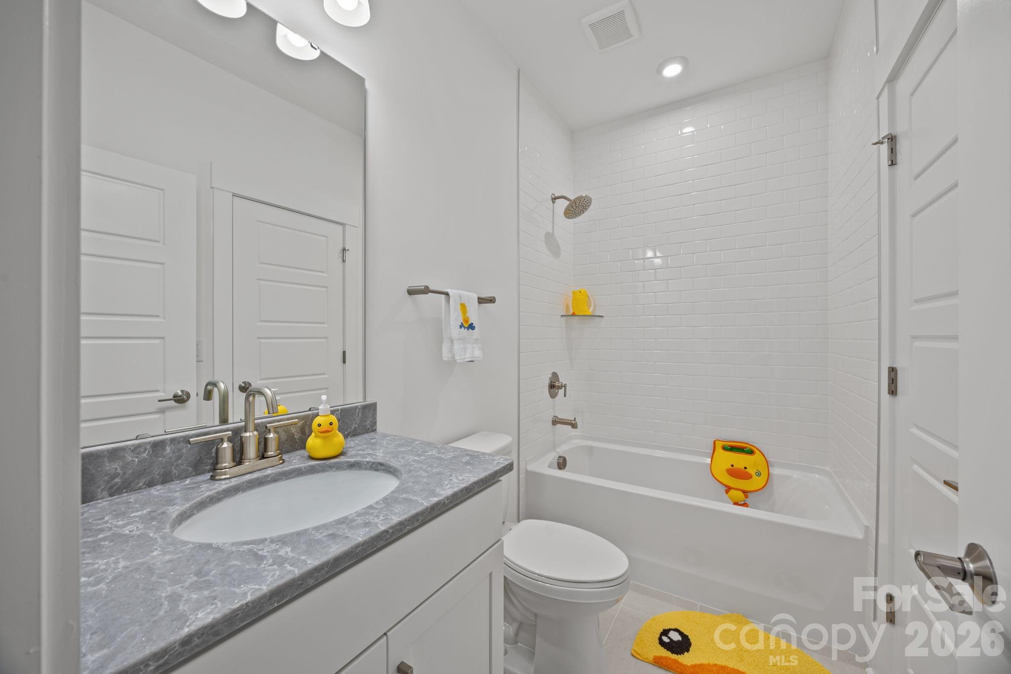8620 Balcony Bridge Road Huntersville, NC 28078 - Photo 42 of 48 a bathroom with a granite countertop sink and a blue white tub
