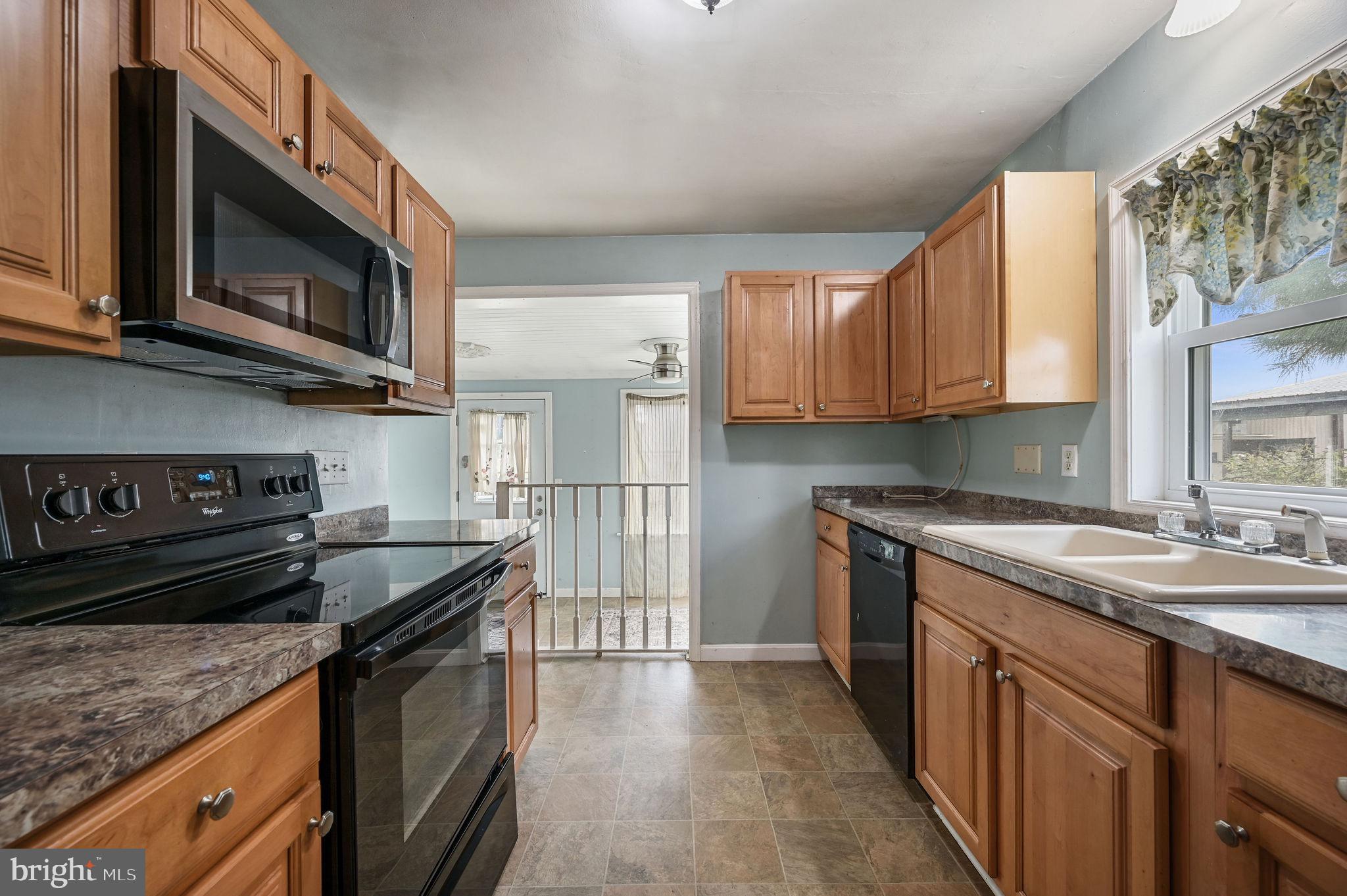 10 North Main Street Magnolia, DE 19962 - Photo 13 of 26 a kitchen with stainless steel appliances granite countertop a stove a sink and a microwave