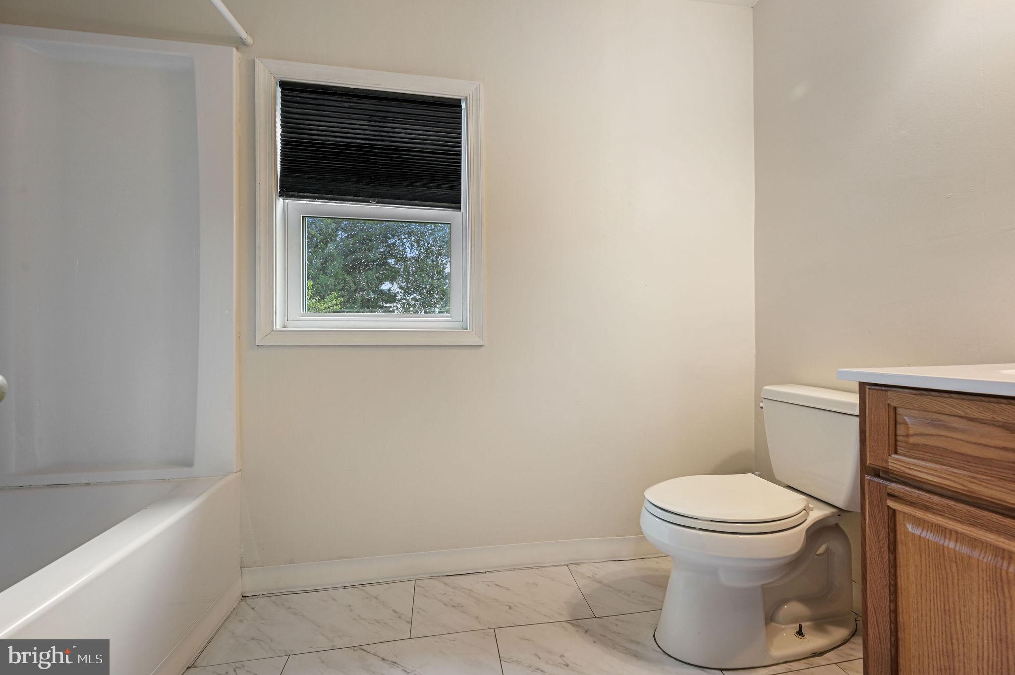 10 North Main Street Magnolia, DE 19962 - Photo 23 of 26 a white toilet sitting next to a bath tub