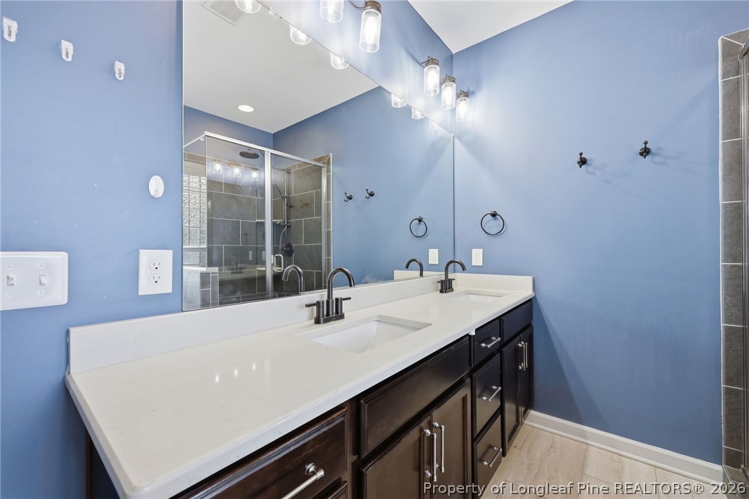33 Colonist Place Cameron, NC 28326 - Photo 26 of 47 a bathroom with a sink double vanity and a mirror