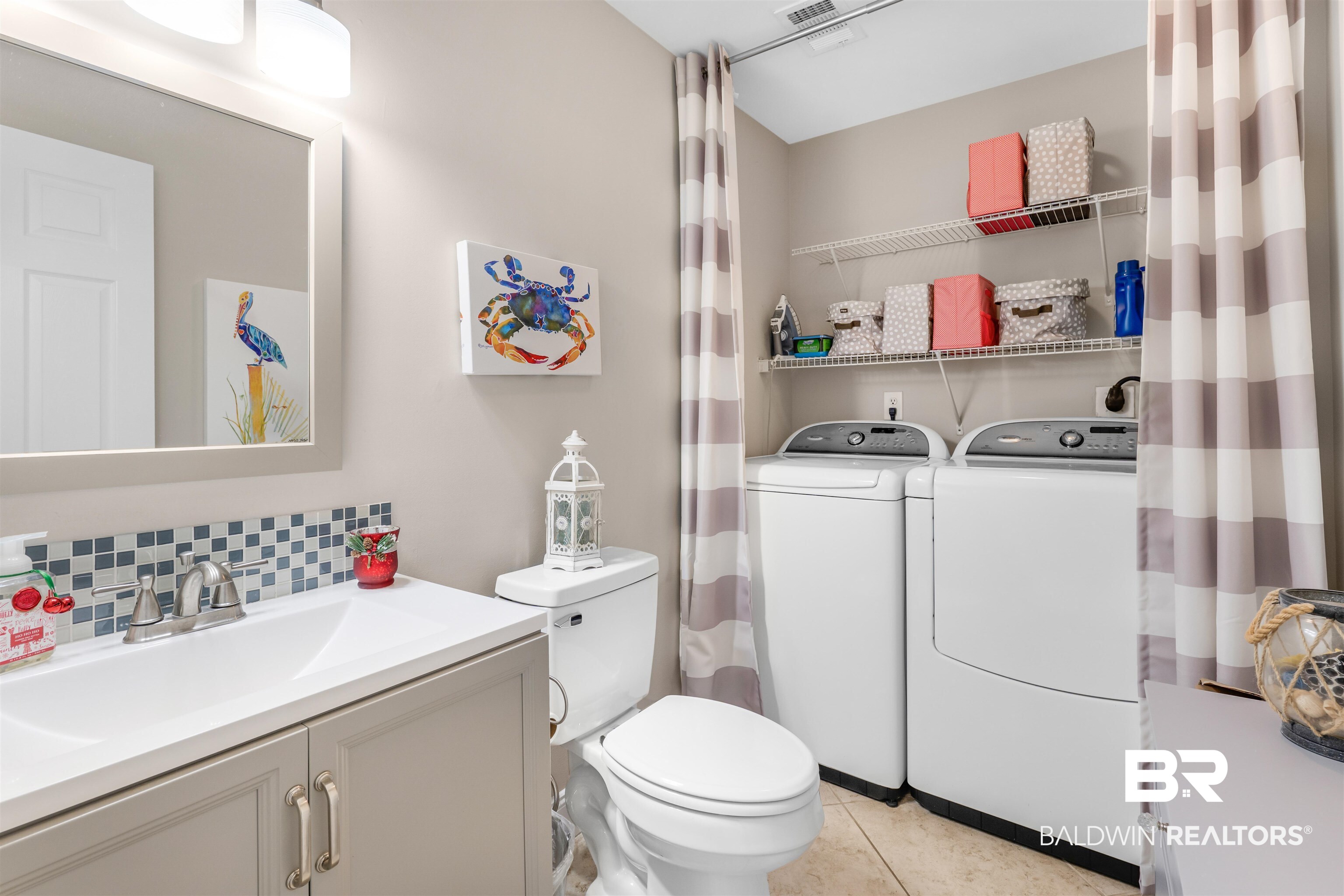 1517 Regency Road, Unit 68 Gulf Shores, AL 36542 - Photo 27 of 43 Bathroom with vanity, tile patterned flooring, washer and dryer, toilet, and tasteful backsplash