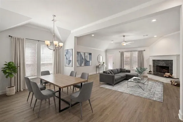 a living room with furniture a chandelier and a table