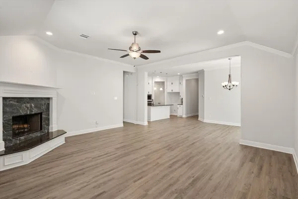 a view of an empty room with a fireplace and a window