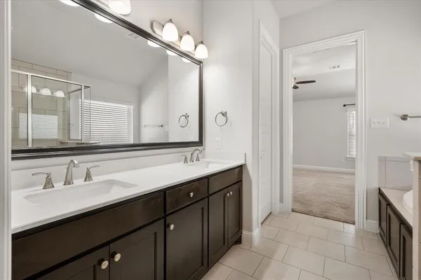 a bathroom with a double vanity sink a and mirror