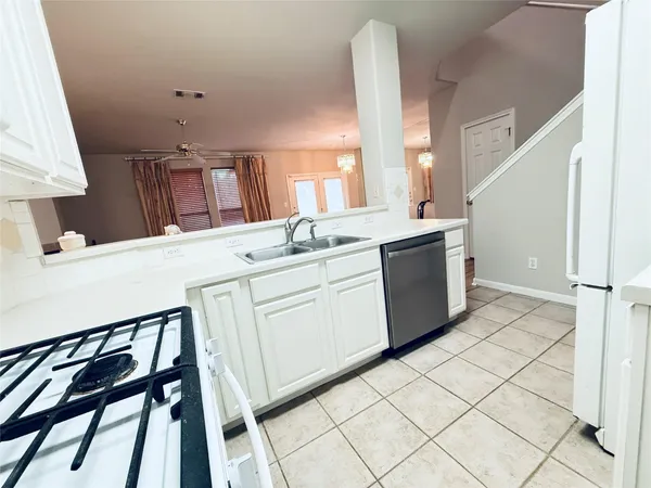 a kitchen with a sink stove and cabinets