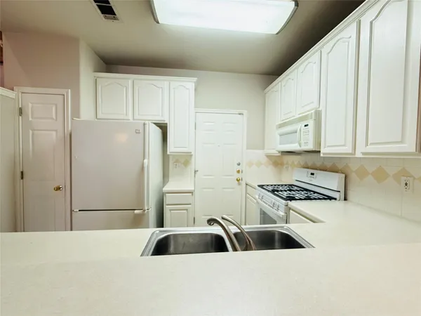 a kitchen with stainless steel appliances a refrigerator and a sink
