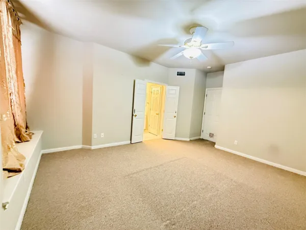 an empty room with windows and entrance