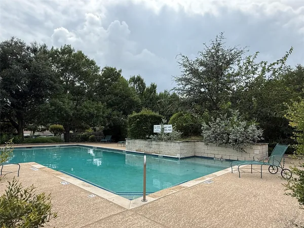 a view of a swimming pool with a yard