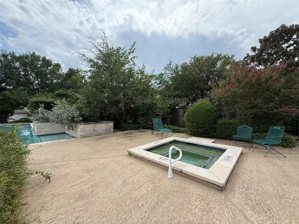 a view of outdoor space with swimming pool and trees in the background