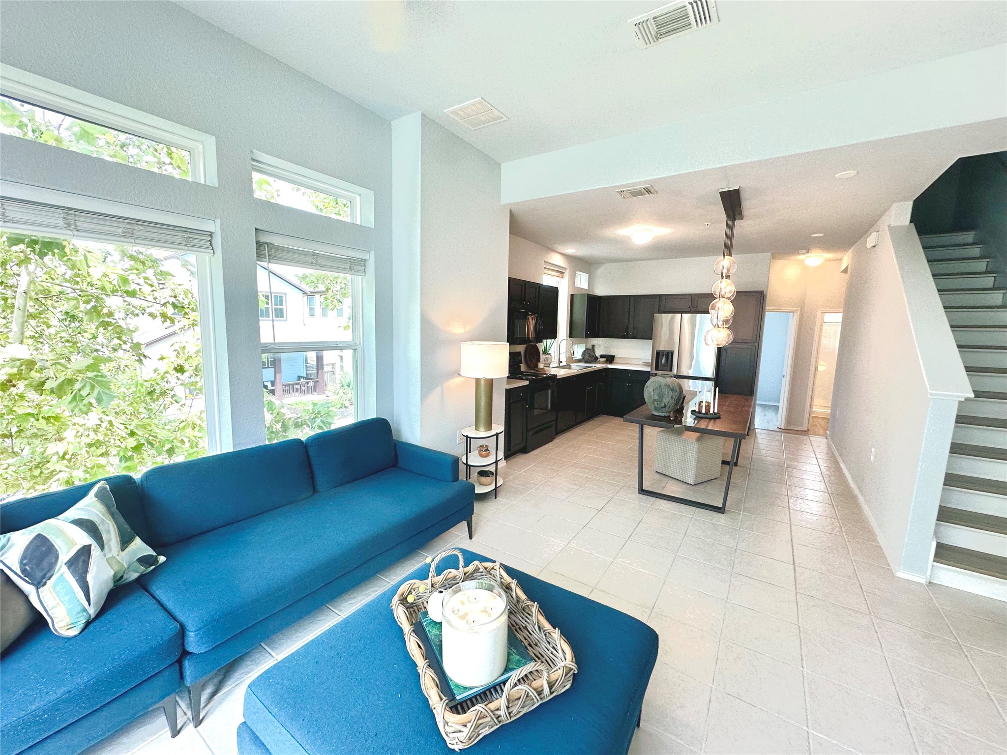 4323 Nitschke Street Austin, TX 78723 - Photo 4 of 11 Living room with stairs and light tile patterned floors