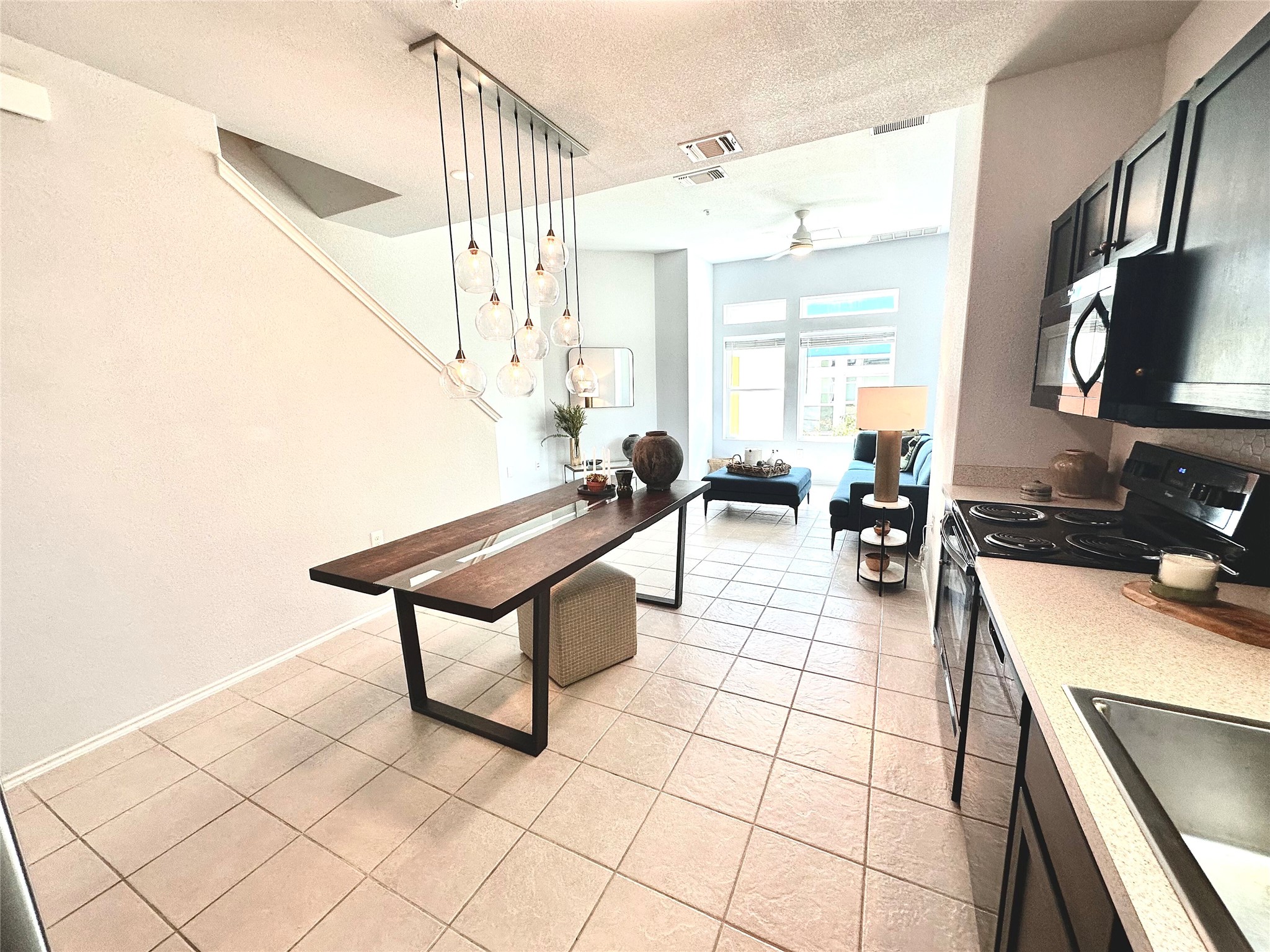 4323 Nitschke Street Austin, TX 78723 - Photo 6 of 11 Kitchen with black electric range oven, light countertops, ceiling fan, dishwasher, and a textured ceiling
