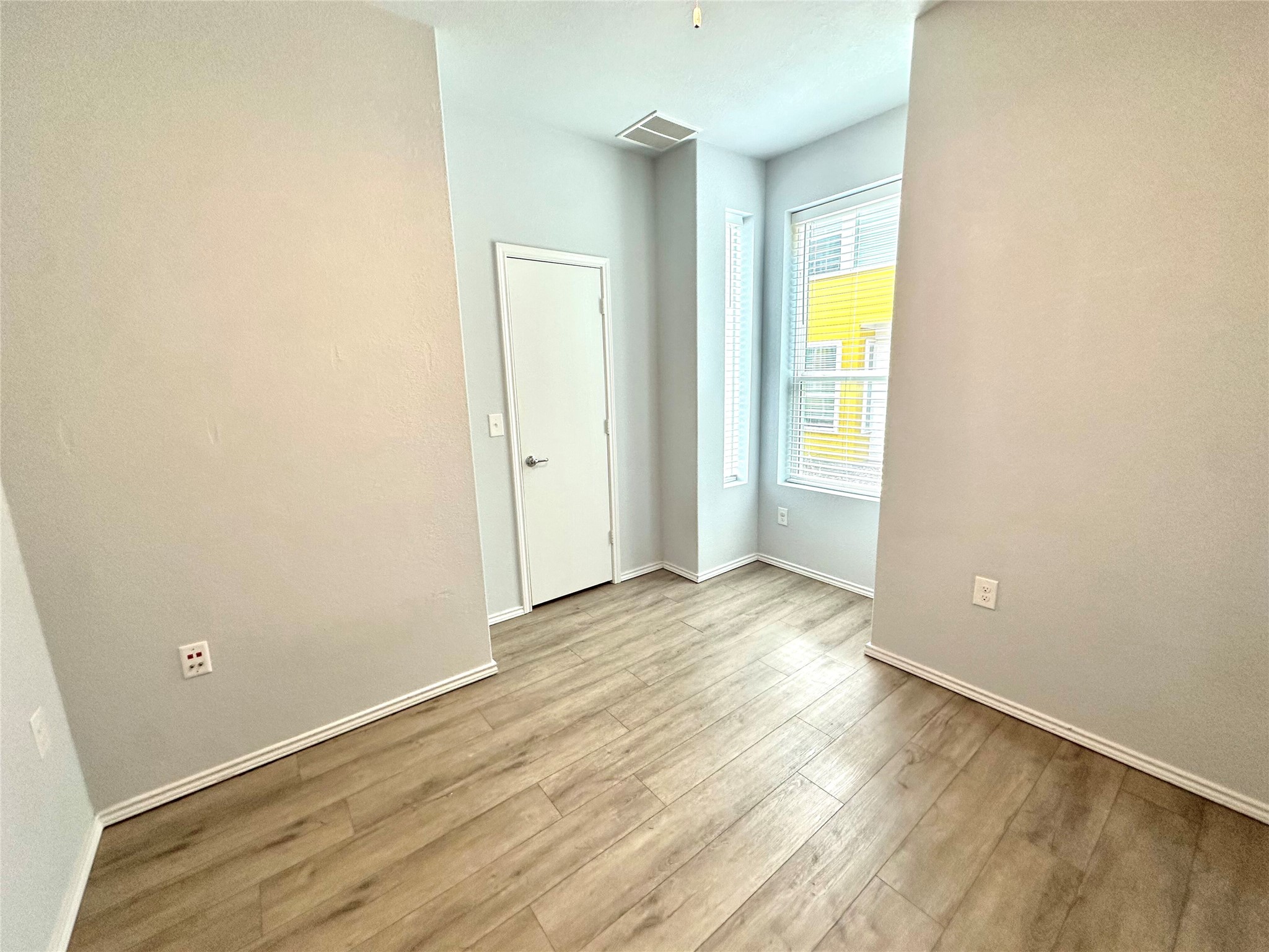4323 Nitschke Street Austin, TX 78723 - Photo 7 of 11 Unfurnished bedroom featuring light wood-style flooring and baseboards