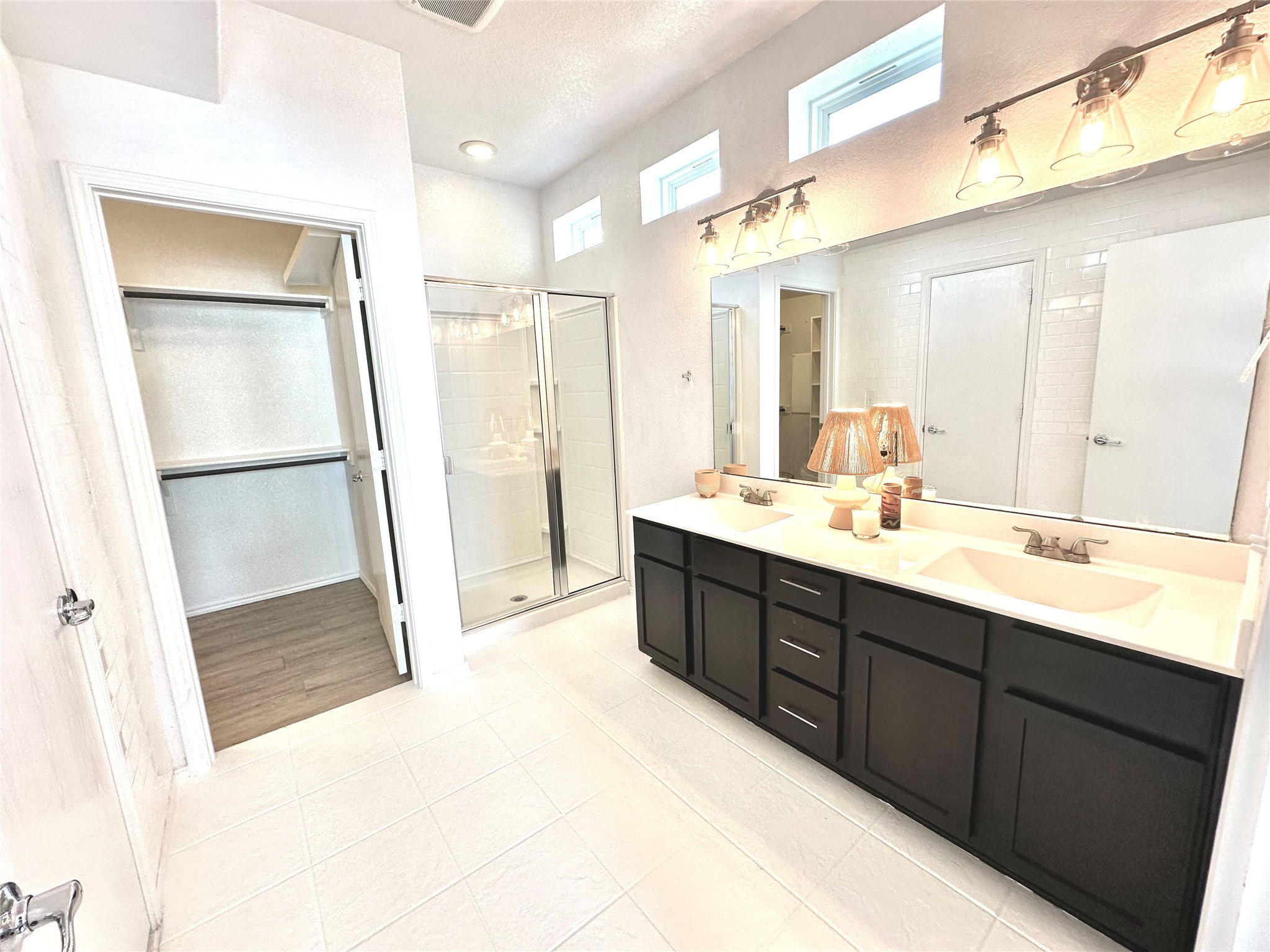 4323 Nitschke Street Austin, TX 78723 - Photo 8 of 11 Full bath with double vanity and a stall shower