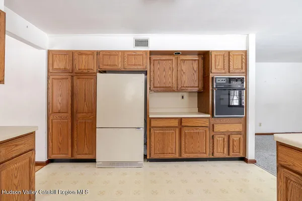 a kitchen with stainless steel appliances granite countertop a refrigerator and a stove