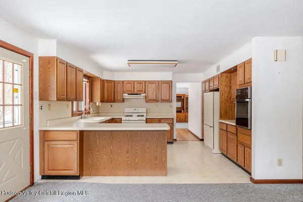 a kitchen with stainless steel appliances a stove refrigerator sink and cabinets