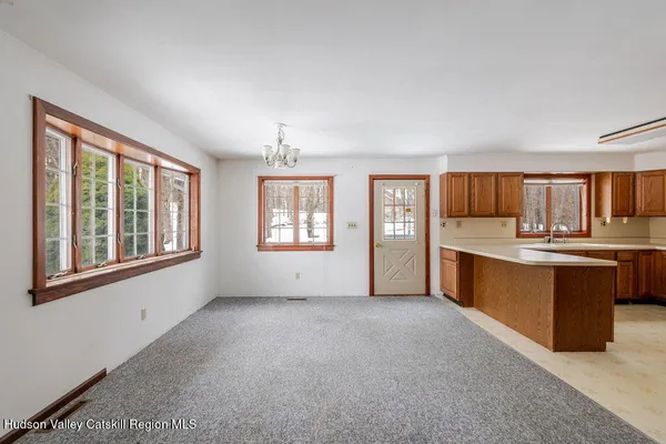 a view of room with window and a ceiling fan