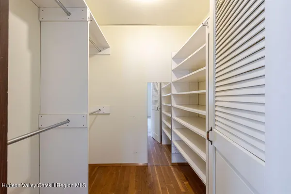 a bathroom with a granite countertop sink a mirror and a shower