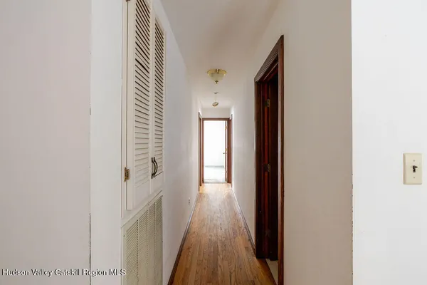 an empty room with windows and closet