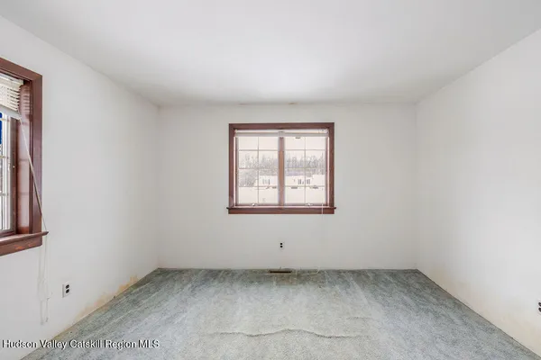 an empty room with windows and closet