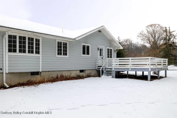 a view of house with outdoor space and wooden fence