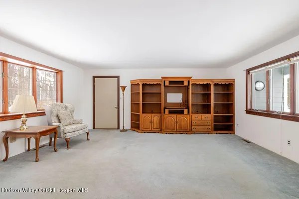 a living room with furniture and large window